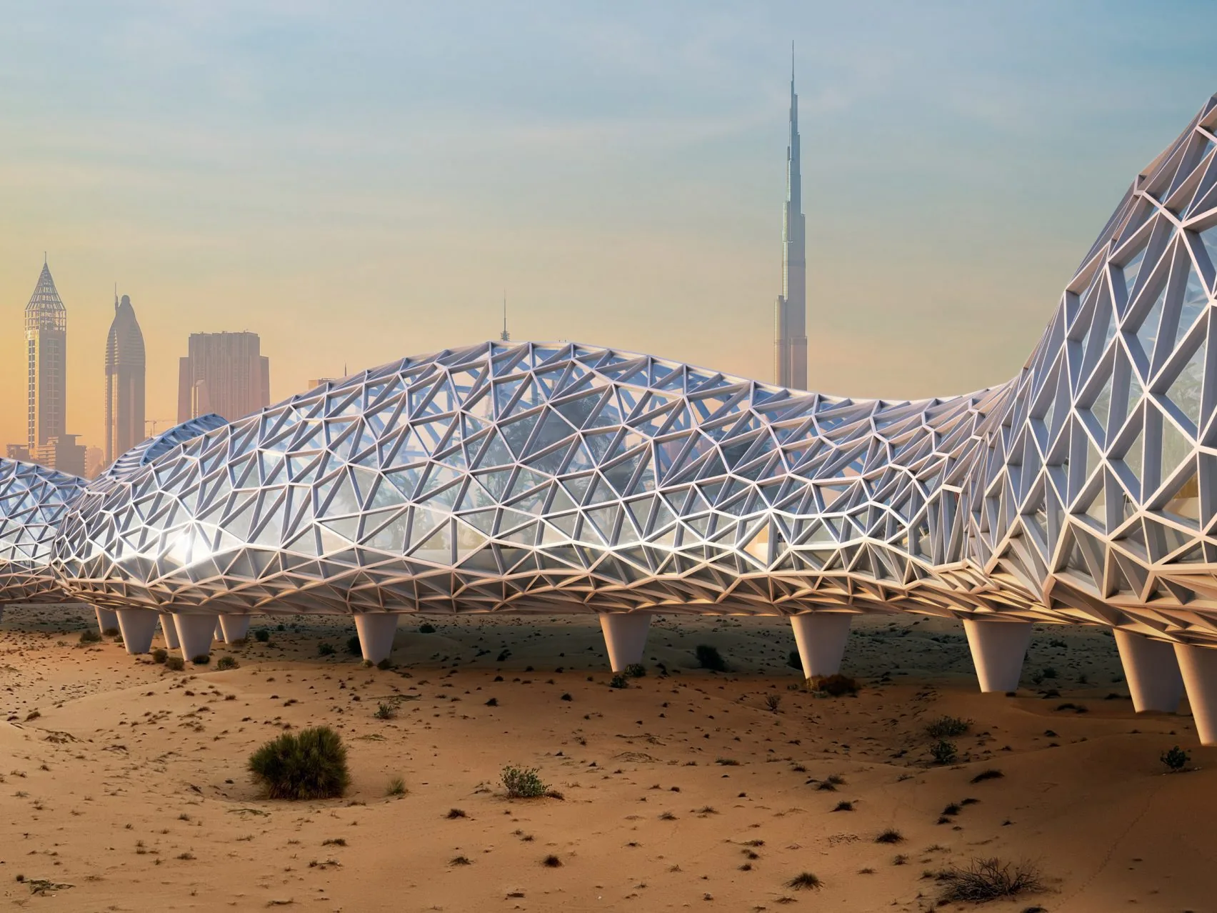 Exterior view of The Loop: a long white latticed glass structure snaking through the desert, with the Dubai skyline and the Burj Khalifa in the background